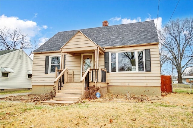 bungalow-style home featuring a front yard