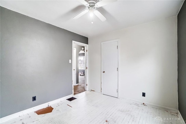 unfurnished room with light wood-type flooring and ceiling fan