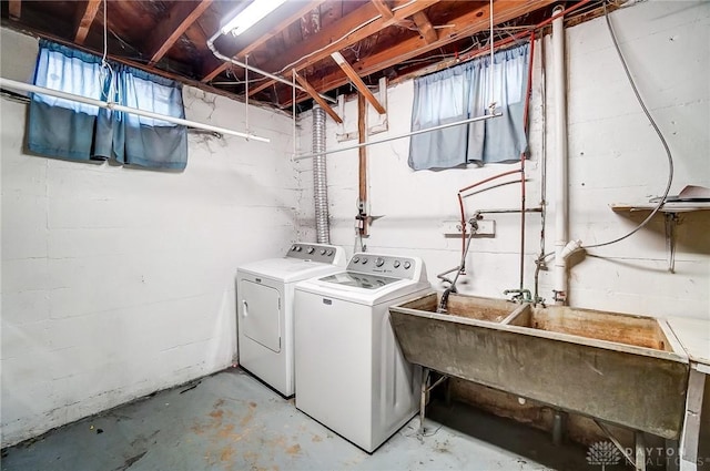 washroom with sink and washing machine and clothes dryer