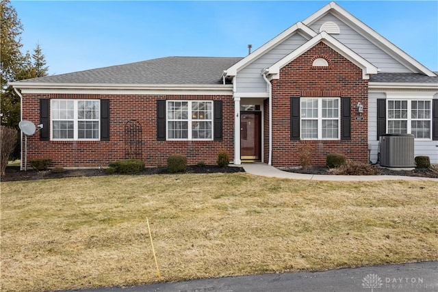 view of front of house with a front lawn and central air condition unit