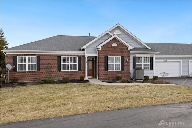 view of front facade featuring central AC, a garage, and a front lawn