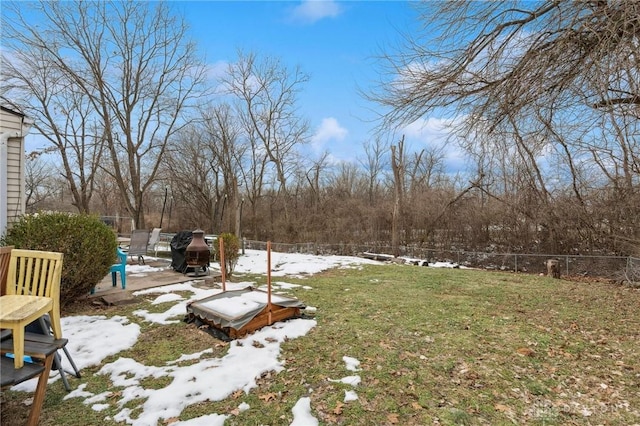 yard covered in snow with a patio area