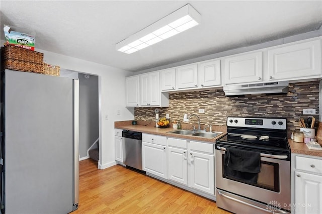 kitchen featuring stainless steel appliances, sink, and white cabinets