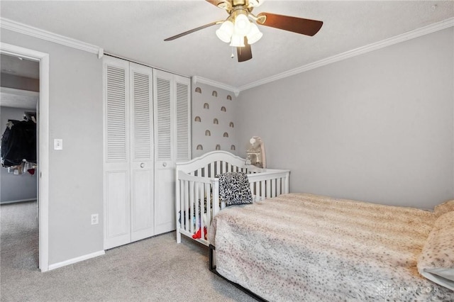 bedroom featuring crown molding, light colored carpet, ceiling fan, and a closet