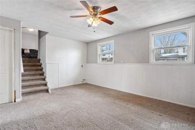 interior space with carpet floors and ceiling fan