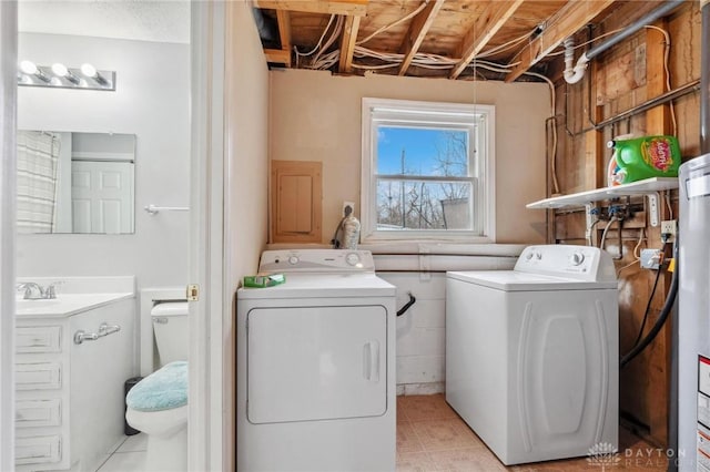 clothes washing area with separate washer and dryer, sink, and light tile patterned floors