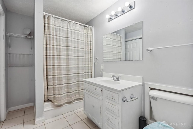 full bathroom with vanity, shower / tub combo, tile patterned floors, and a textured ceiling