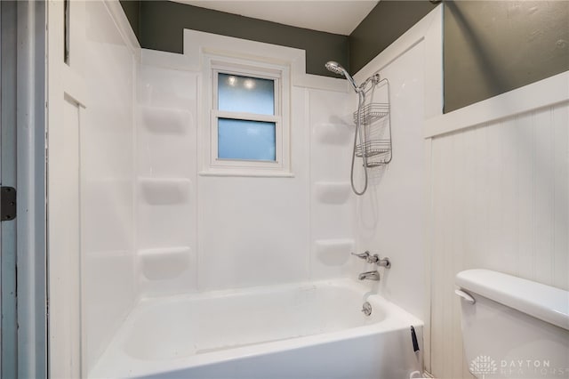 bathroom featuring shower / tub combination and toilet