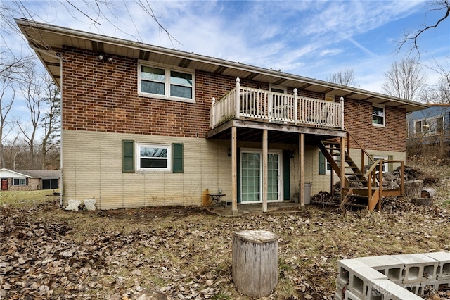 rear view of property featuring a wooden deck