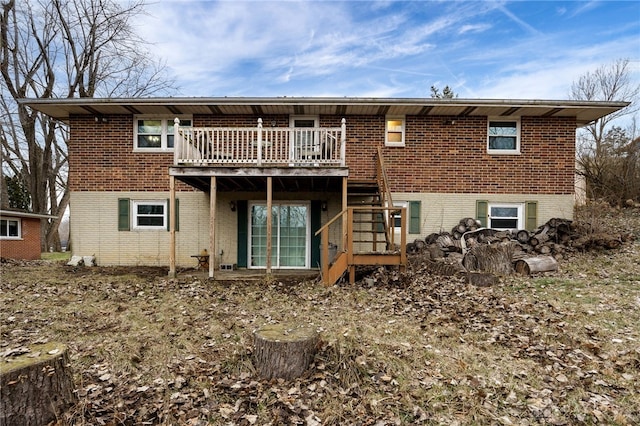 rear view of property featuring a wooden deck