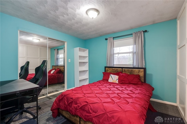 bedroom featuring a textured ceiling and a closet