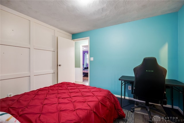 bedroom with a textured ceiling and a closet