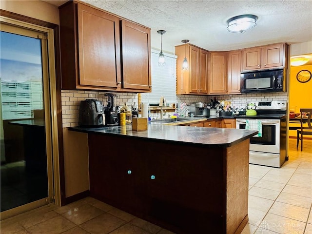 kitchen with electric stove, sink, pendant lighting, light tile patterned floors, and backsplash