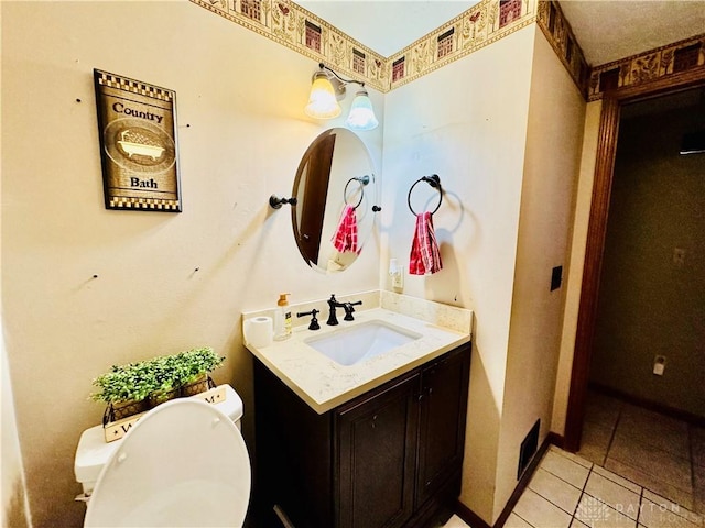 bathroom featuring tile patterned flooring, vanity, and toilet