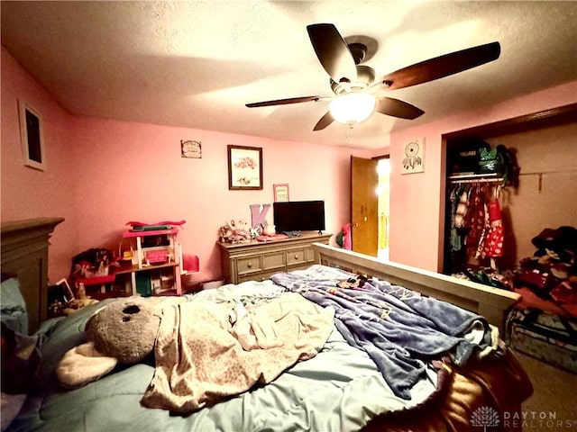 bedroom featuring ceiling fan and a closet