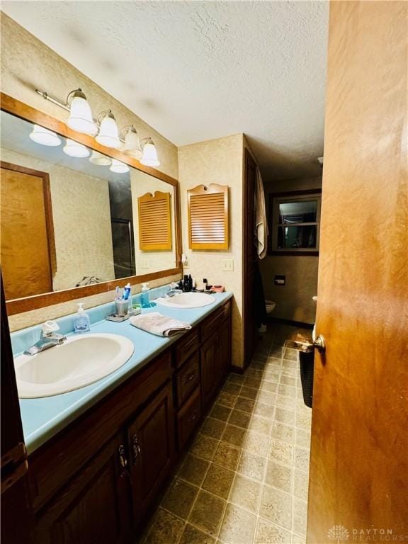 bathroom featuring vanity and a textured ceiling