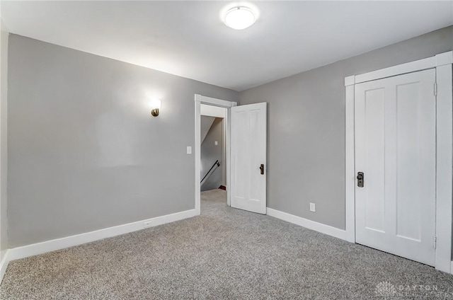 unfurnished bedroom with carpet and a closet