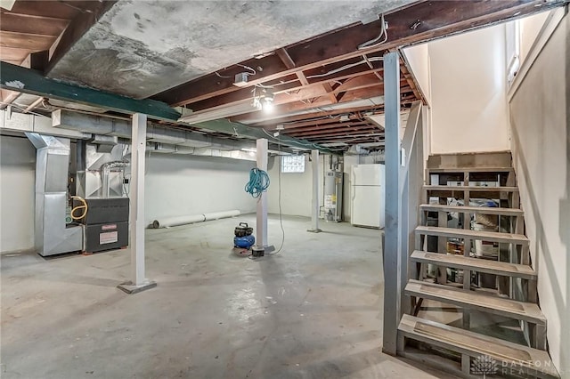 basement featuring water heater, white fridge, and heating unit