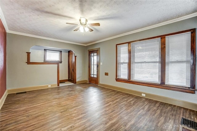 foyer entrance featuring wood-type flooring, ornamental molding, ceiling fan, and a textured ceiling