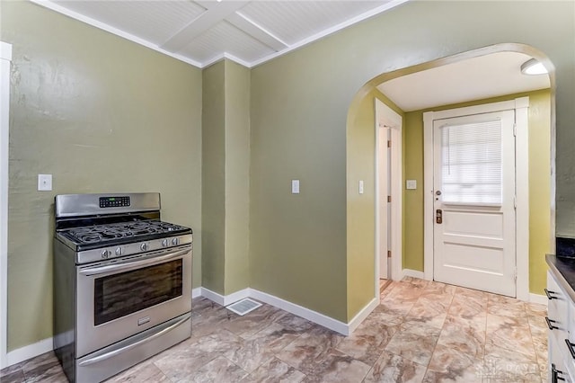 kitchen with stainless steel range with gas stovetop and white cabinets