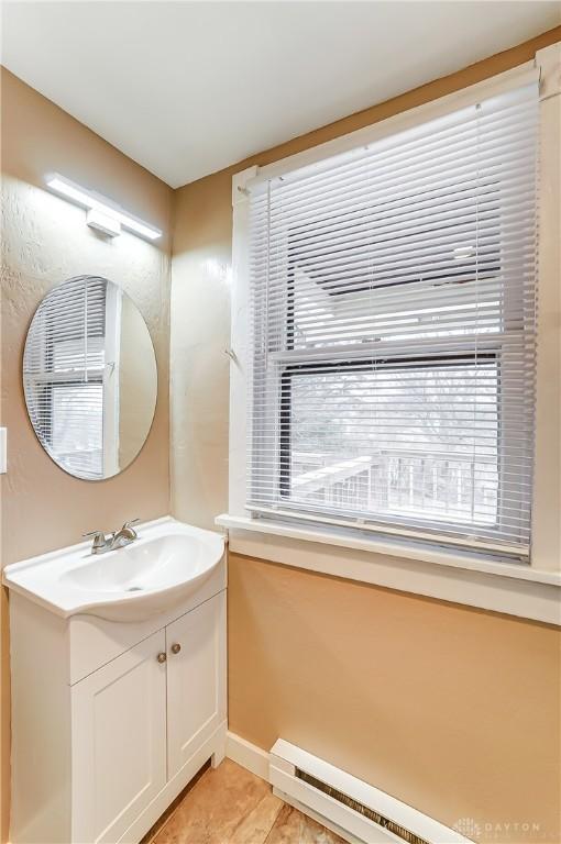 bathroom featuring vanity and a baseboard heating unit