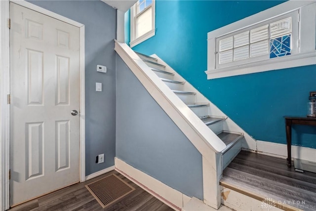 stairs with hardwood / wood-style floors