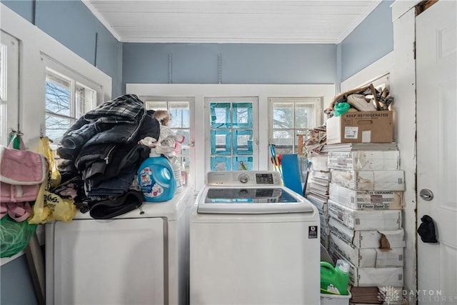 laundry room with ornamental molding, washer and dryer, and a wealth of natural light