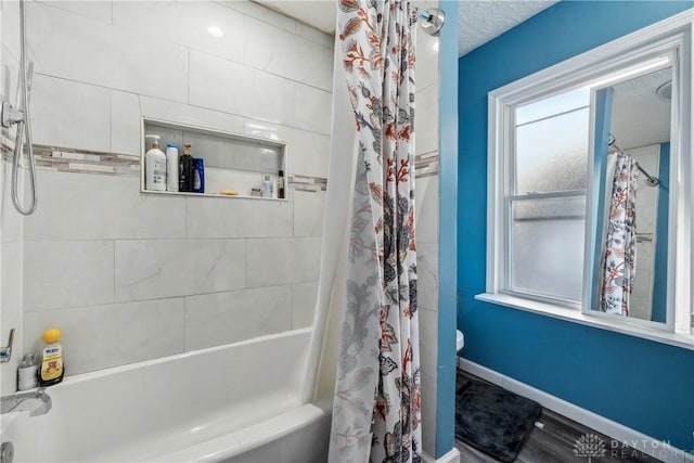 bathroom with shower / bath combo with shower curtain