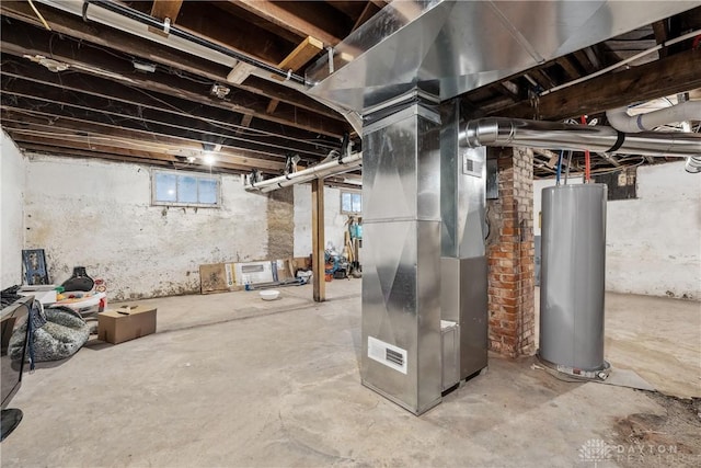 basement featuring heating unit, water heater, and a healthy amount of sunlight