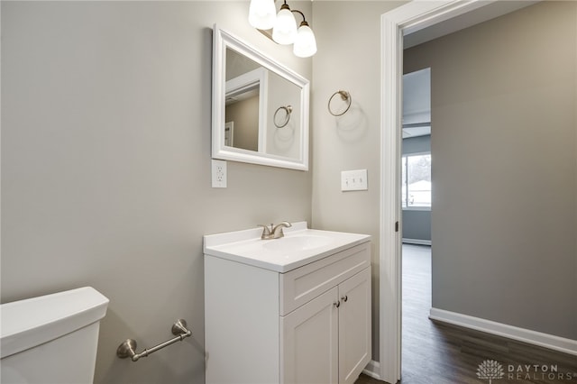 bathroom featuring vanity, toilet, and wood-type flooring