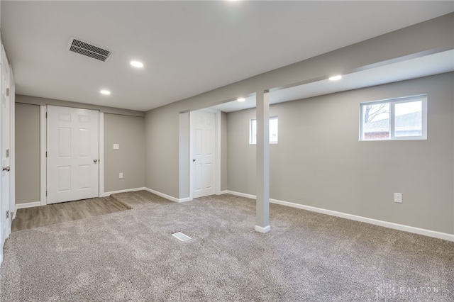 basement featuring light carpet