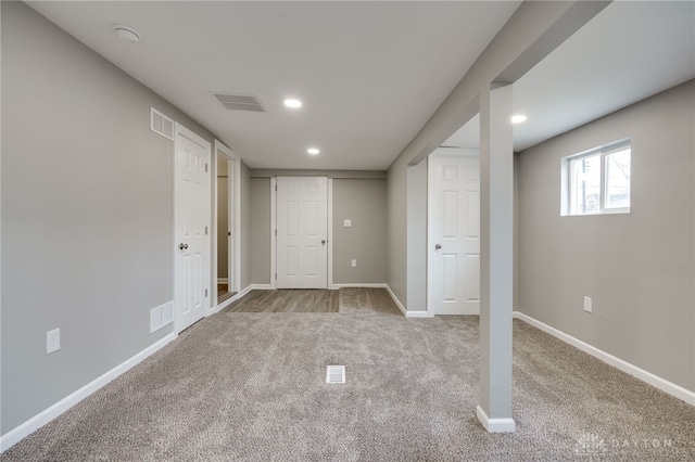 basement featuring light colored carpet