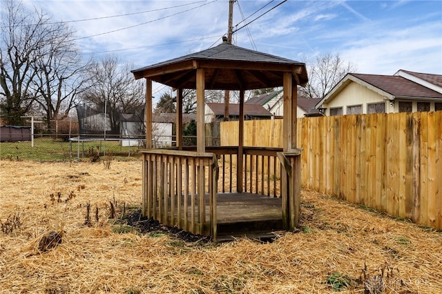 wooden deck with a trampoline and a gazebo