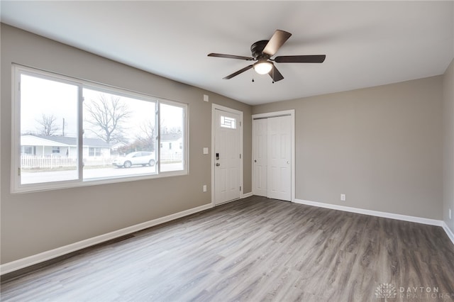 spare room with hardwood / wood-style flooring and ceiling fan