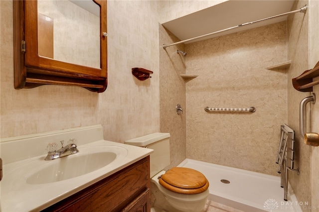 bathroom with walk in shower, vanity, and toilet