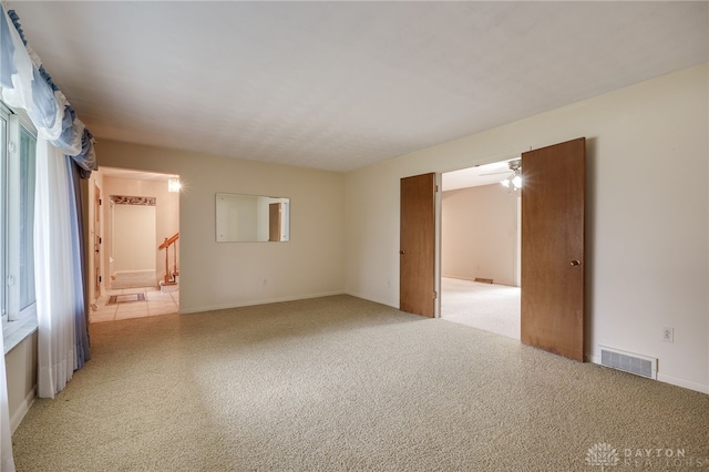 spare room featuring stairs and visible vents