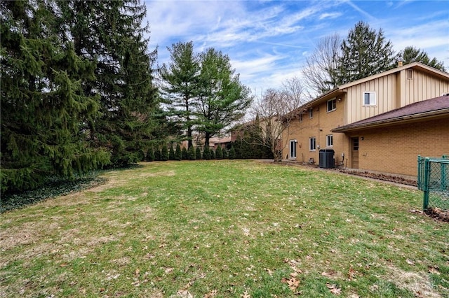 view of yard featuring fence and cooling unit