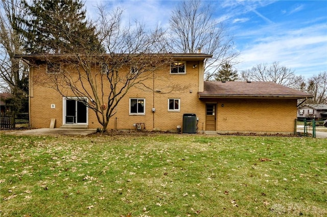 back of house with a patio, fence, a yard, central air condition unit, and brick siding