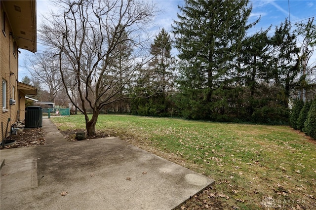 view of yard with fence, cooling unit, and a patio