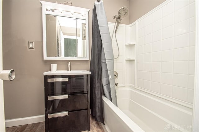 bathroom with shower / tub combo, hardwood / wood-style floors, and vanity