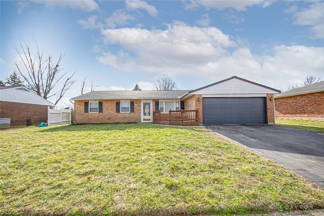 ranch-style home with a garage and a front yard