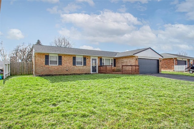 single story home with a garage and a front lawn