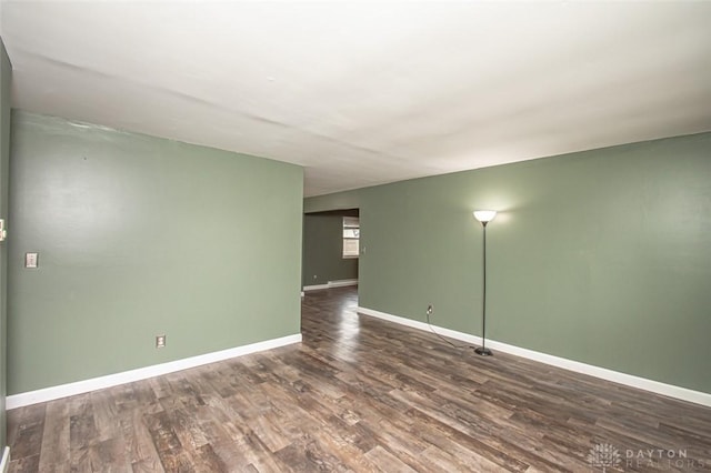 spare room featuring dark wood-type flooring