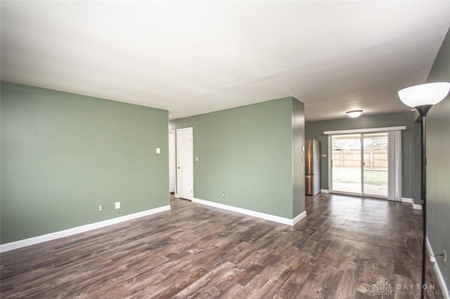 spare room featuring dark wood-type flooring