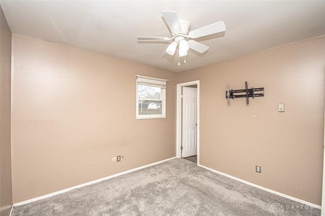 unfurnished room with ceiling fan and light colored carpet