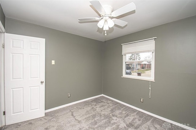 spare room with light colored carpet and ceiling fan