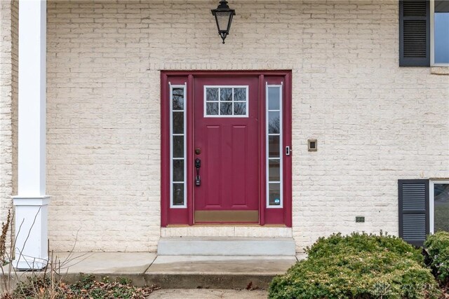 entrance to property with brick siding