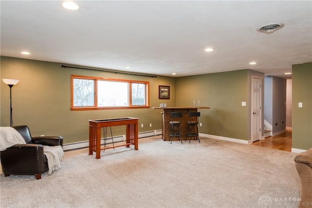 sitting room with carpet, recessed lighting, visible vents, a bar, and baseboards