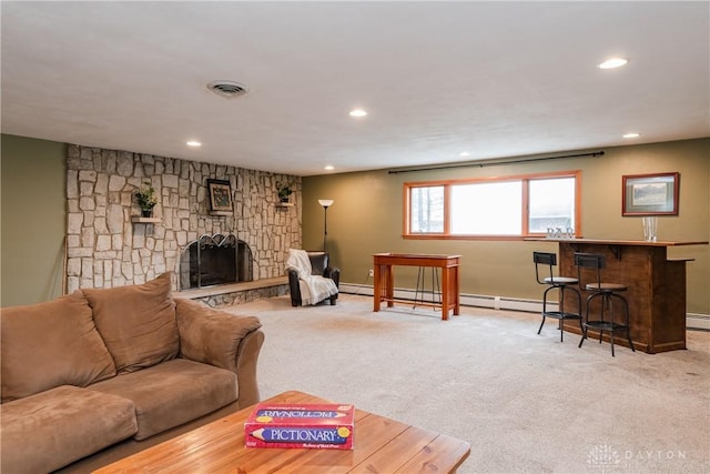 carpeted living room featuring recessed lighting, a fireplace, visible vents, baseboards, and a bar