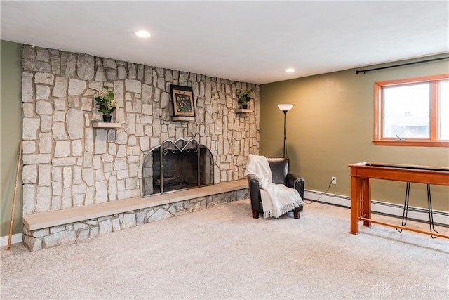 living area featuring carpet floors, recessed lighting, a baseboard heating unit, and a fireplace